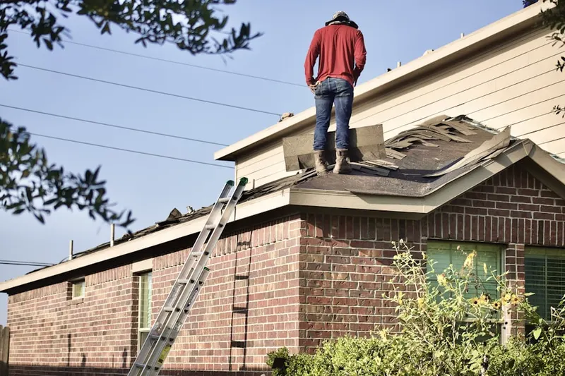Professional roofer working on a residential roof in Champaign